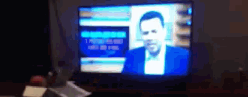a blurry picture of a man 's face on a television screen