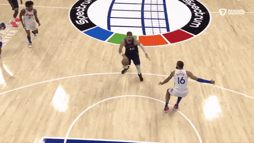 a basketball game is being played on a court that says spectrum on it