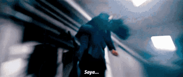 a man in a suit is carrying another man on his shoulders and says saya .
