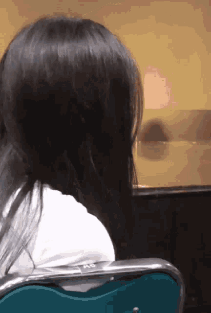 a woman sits in a chair with a sticker that says ab
