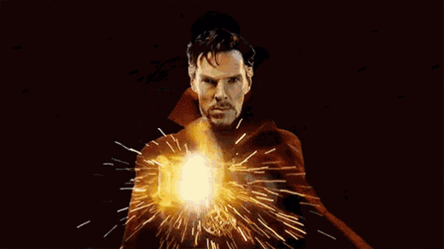 a man in a cape is standing in front of a black background with a lot of sparks coming out of him .