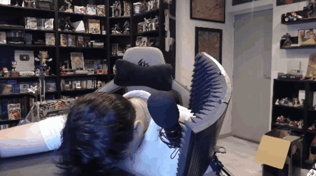 a man is laying in a chair with a 4k logo on the back