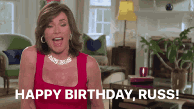 a woman in a red dress is shouting happy birthday russ