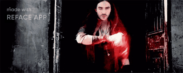 a man in a red cape is standing in a doorway with the words made with reface app behind him