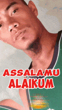 a man in a green shirt with the words assalamu alaikum on the bottom