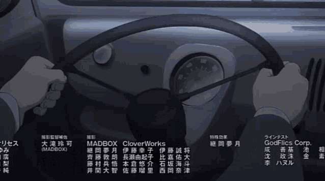 a person is holding a steering wheel with the name madbox on it