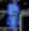 a blurry picture of a blue object in a dark room with a black background .