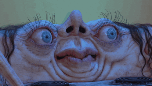 a close up of a woman 's face with a surprised expression
