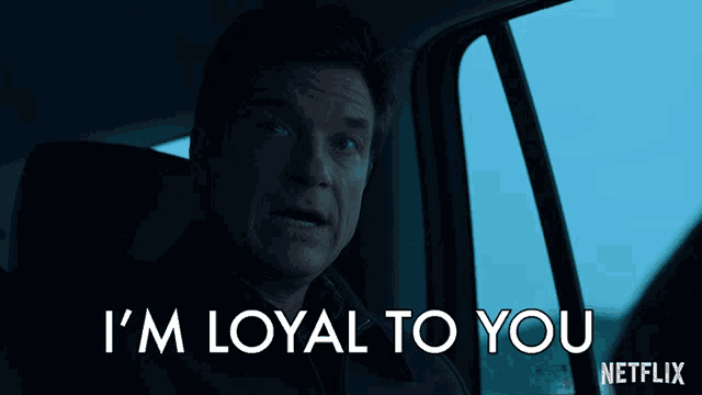 a man in a car with the words i 'm loyal to you netflix