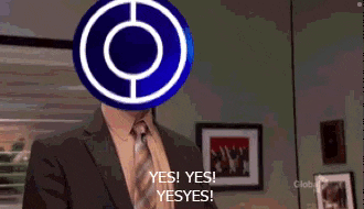 a man in a suit and tie is holding a blue circle in front of his face .