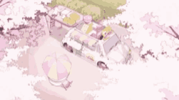 a car is parked under a cherry blossom tree with a table and umbrella .