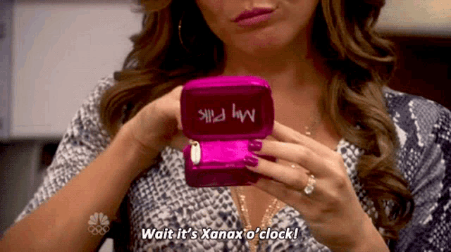 a woman is holding a box that says my pill on it