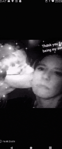 a woman is smoking a cigarette in a black and white photo on a cell phone .