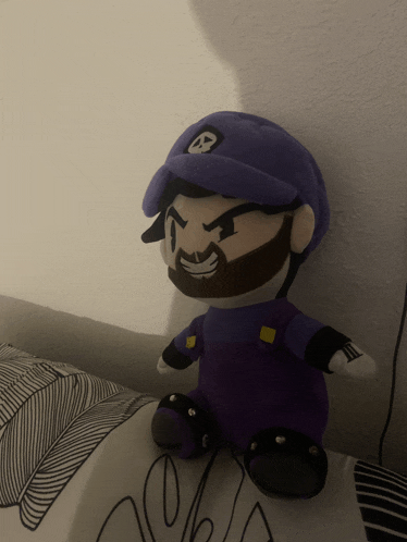 a stuffed toy of a man with a beard and a purple hat