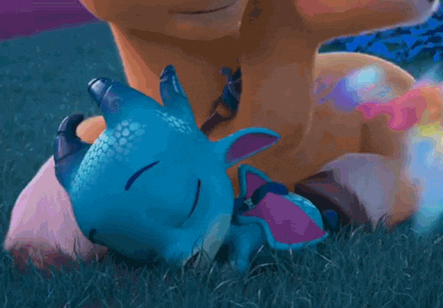 a cartoon dragon is laying on a person 's lap .