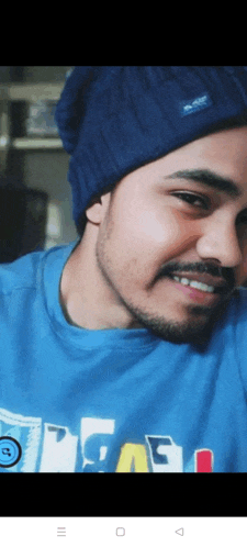 a man wearing a blue beanie and a blue shirt that says chicago