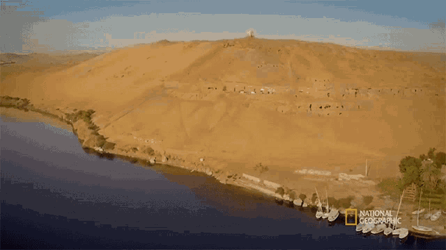 an aerial view of a desert landscape with a national geographic logo in the foreground