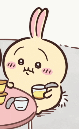 a cartoon rabbit is sitting at a table with a cup of coffee
