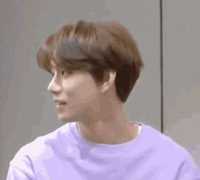a close up of a person wearing a purple sweatshirt .