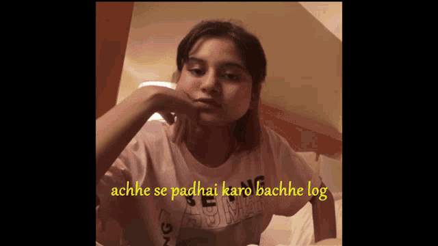 a girl in a pink shirt with the words ache se padhai karo bachhe log on the bottom