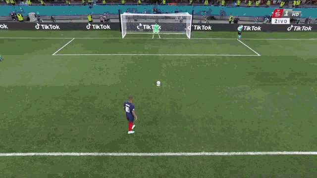 a soccer player with the number 1 on his jersey stands in front of a net