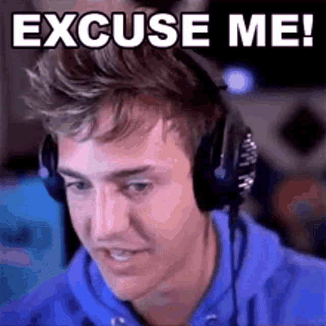 a man wearing headphones is saying `` excuse me '' while looking at a computer screen .