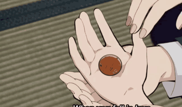 a person is holding a copper coin in their hand with the words when you fall in love on the bottom