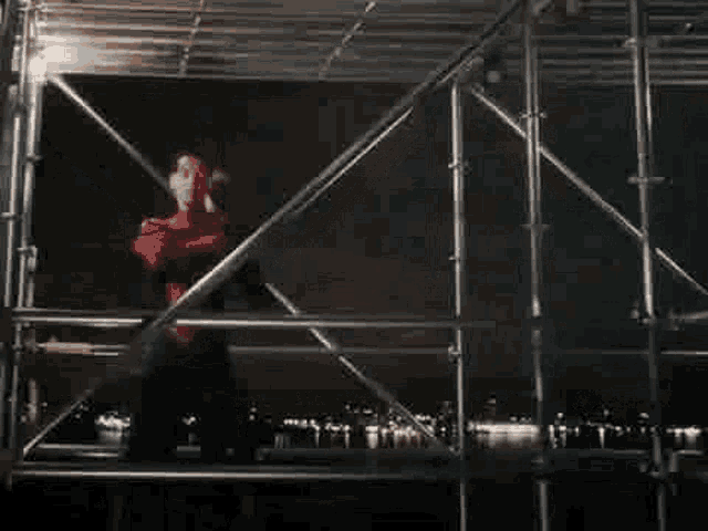 a man and a woman are standing next to each other in a room with scaffolding .