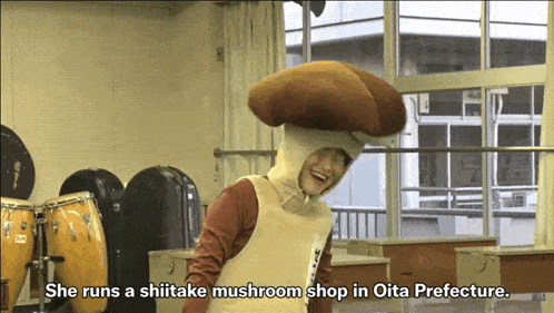a person in a mushroom costume says she runs a shiitake mushroom shop in oita prefecture