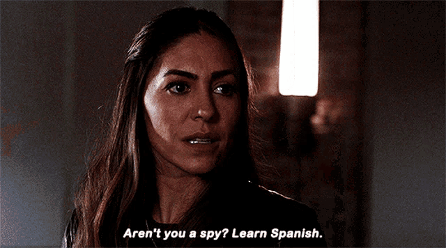 a woman says " aren t you a spy ? learn spanish "
