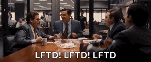 a group of men are sitting around a table with the words lftd lftd lftd written on it