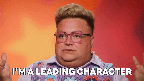 a man wearing glasses and a purple shirt says i 'm a leading character