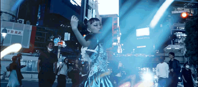 a woman is dancing in front of a sign that says ' a ' on it