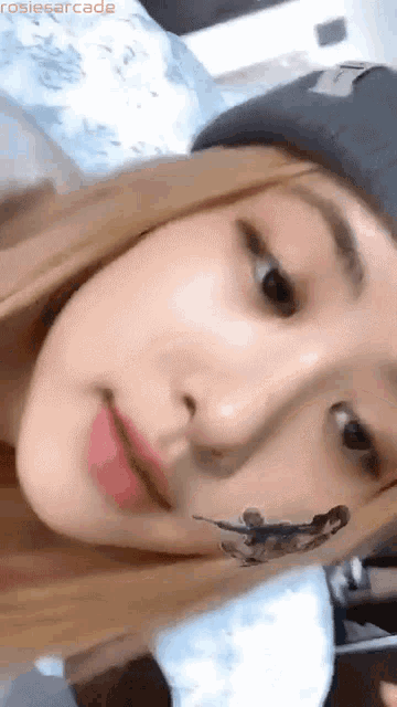 a close up of a woman 's face with a sticker on her face