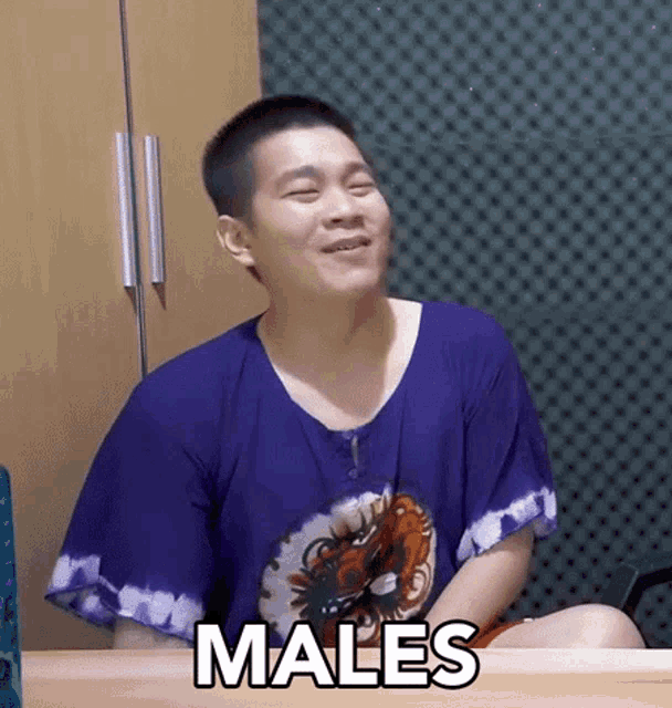 a man wearing a purple shirt with the word males on it