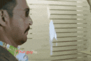 a man with a mustache and sunglasses says " that guy " in red letters