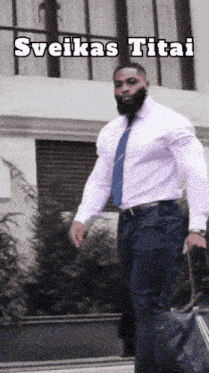 a man in a white shirt and tie is carrying a suitcase and the caption sveikas titai is above him