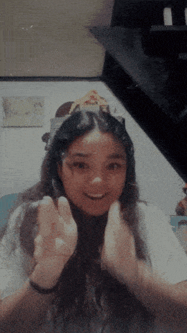 a girl wearing a headband with a picture of a giraffe on the wall behind her