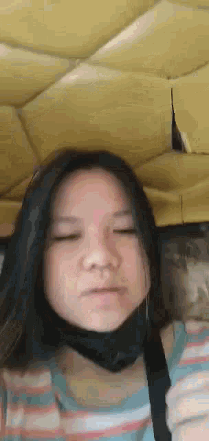a young girl wearing a mask is making a funny face .