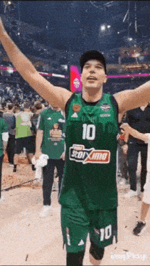 a basketball player wearing a green jersey with the number 10 on it .