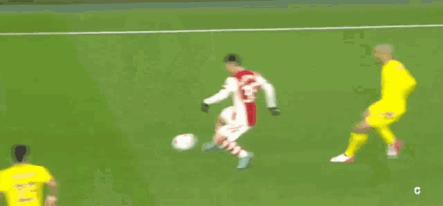 a blurry picture of a soccer game with a player wearing a number 14 jersey