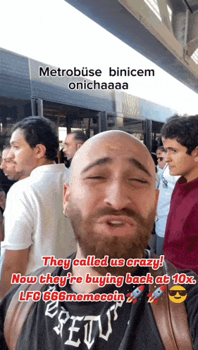 a bald man with a beard is standing in front of a crowd of people and they called us crazy