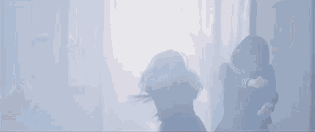 a group of girls in black uniforms are dancing in a dark hallway