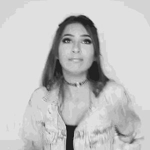 a black and white photo of a woman in a denim jacket .