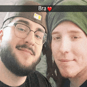 two men are posing for a picture and one has bra written on his hat