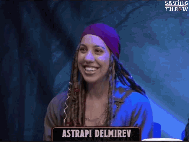a woman with dreadlocks is smiling in front of a sign that says " astrapi delmirev "