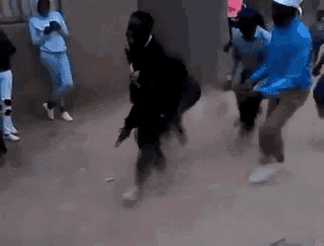 a group of people are dancing in a room while wearing face masks .