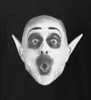 a close up of a man 's face with a surprised look on his face