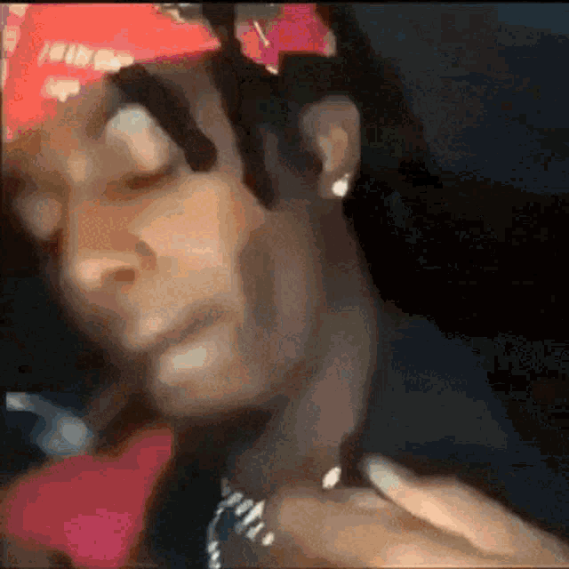 a close up of a person 's face with a red bandana on
