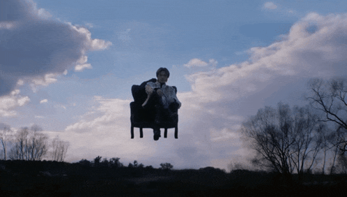 a person sitting in a chair in the sky